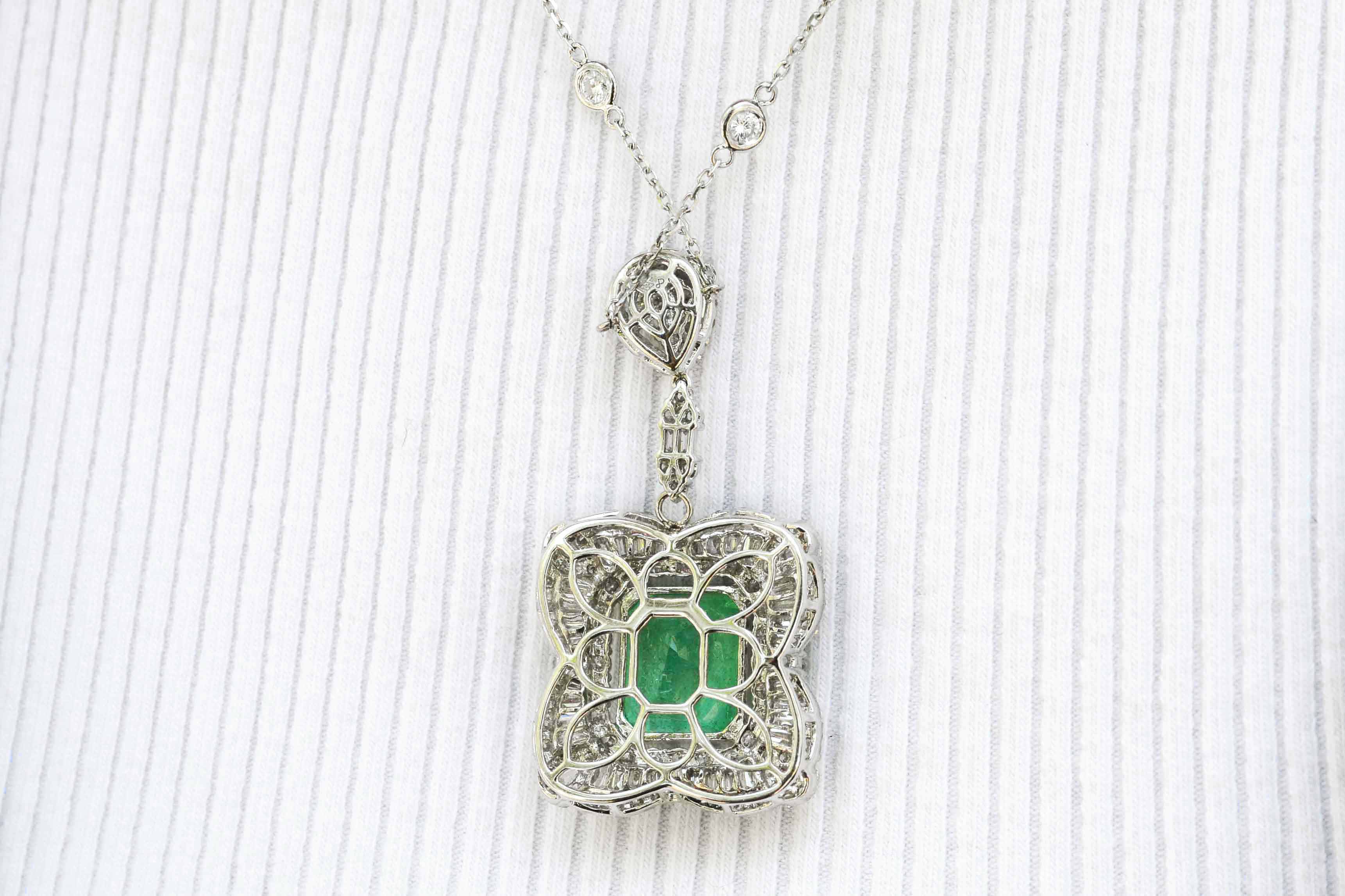 The emerald cut gem of nearly 8 carats glows with a vivid green fire in this white gold pendant necklace.