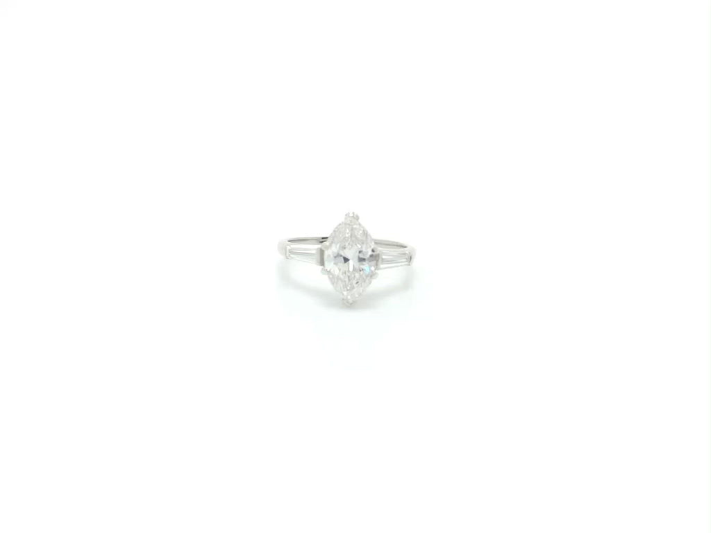 An over two carat marquise cut diamond in a 3 stone solitaire engagement ring design.