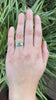 The Colombian emerald set in this engagement ring has good, transparent clarity.