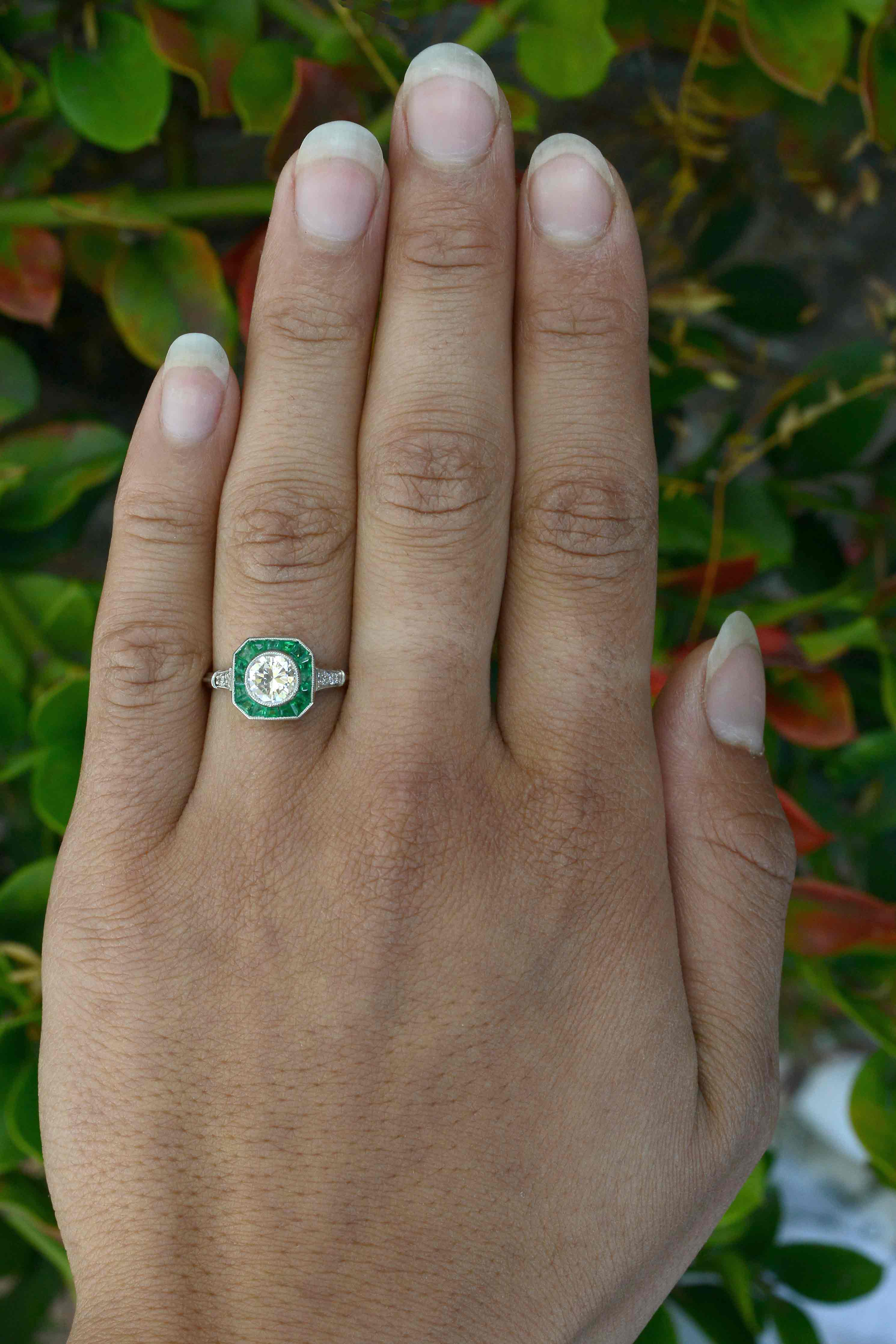 A square emerald halo diamond wedding ring.
