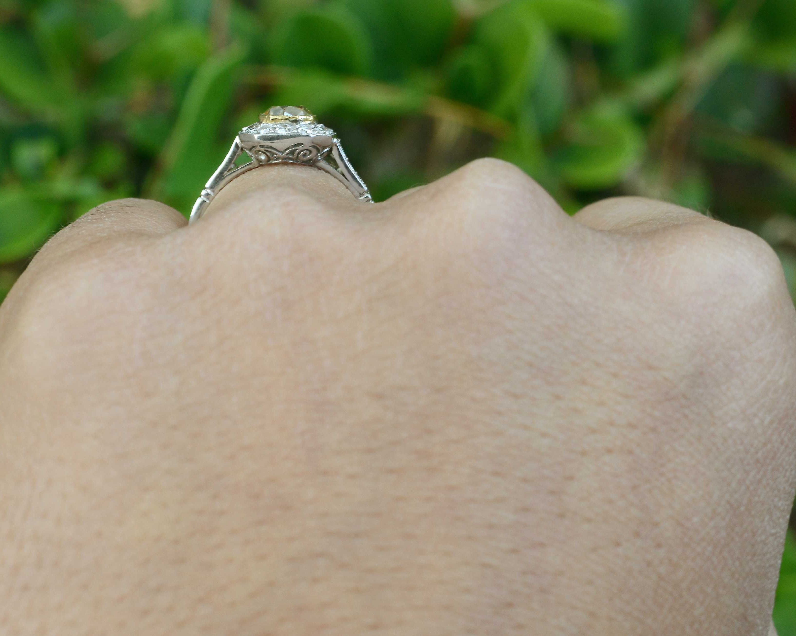 Fancy light yellow diamond halo engagement ring.