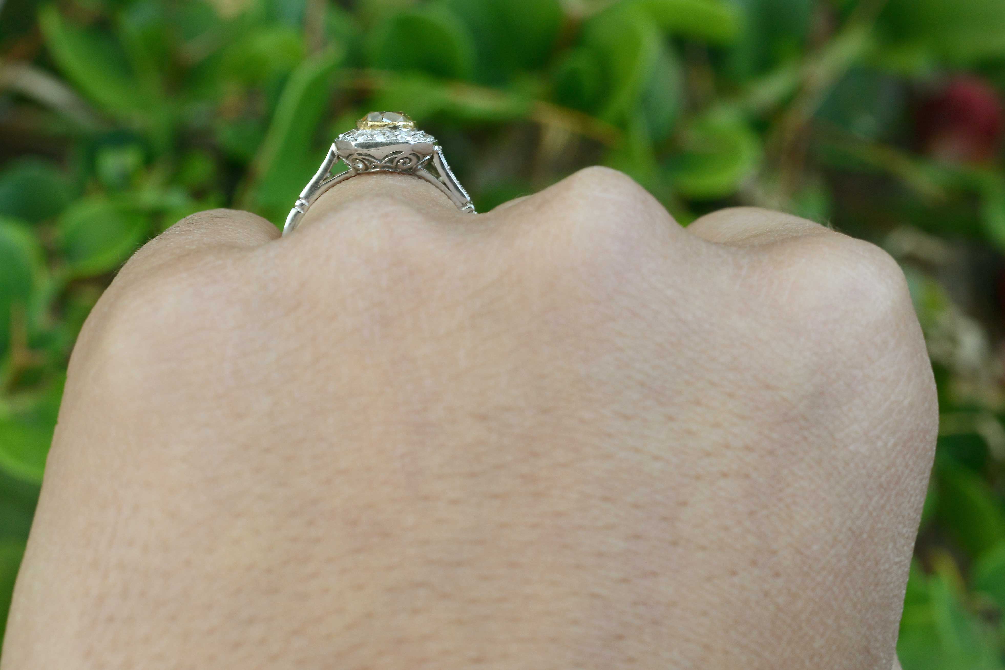 Fancy light yellow diamond halo engagement ring.