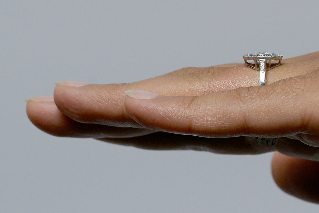 Diamonds on the band of the engagement ring.