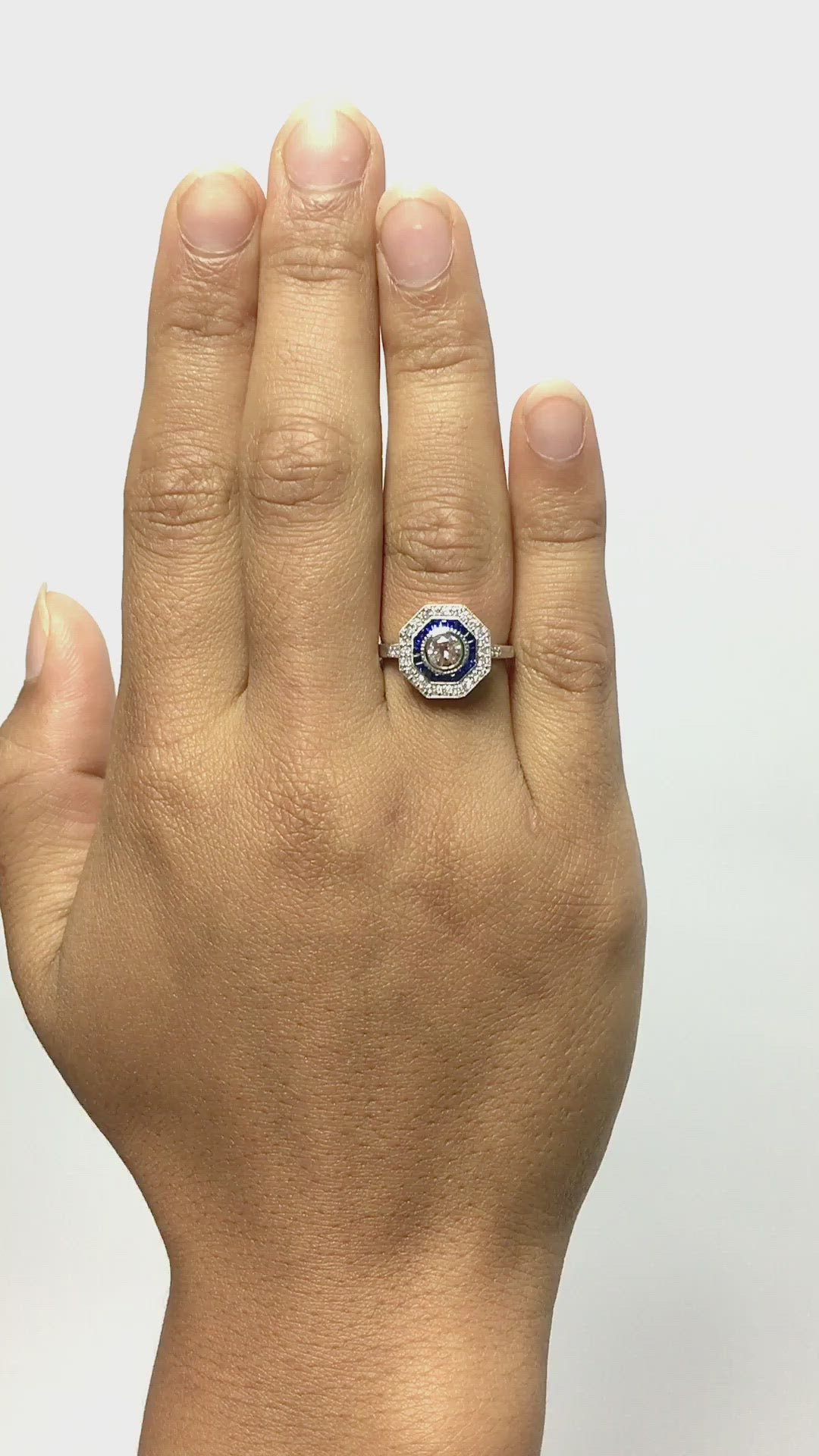 This engagement ring has two halos, with sapphires and diamonds.