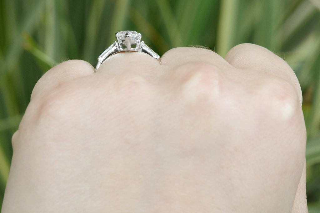A boat shaped profile, 3 diamond engagement ring.