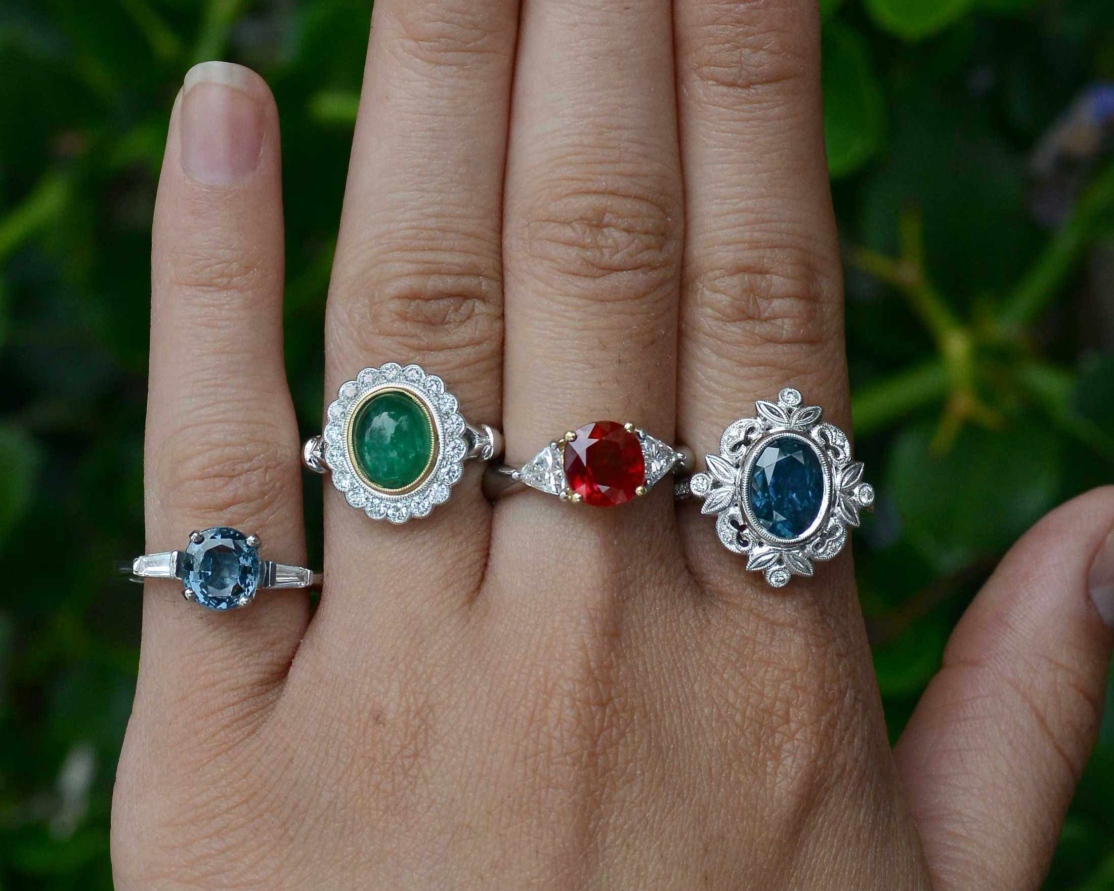A collection of gem and diamond halo engaggement rings.