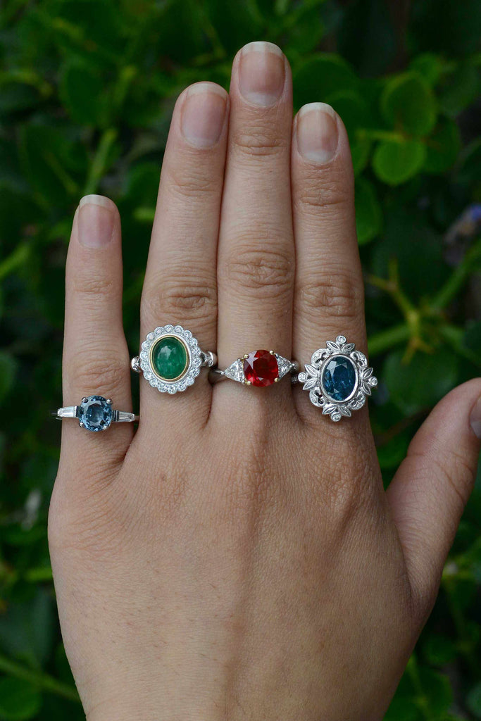 A collection of gem and diamond halo engaggement rings.