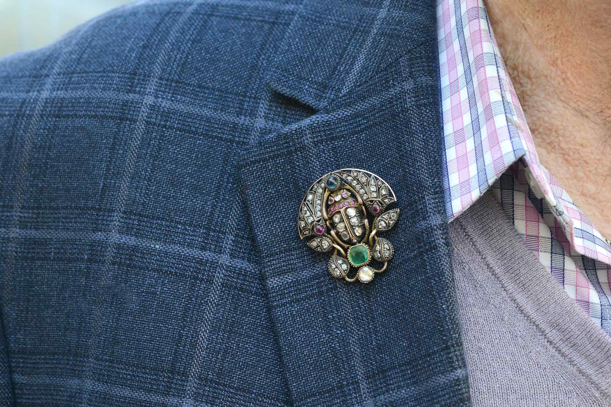 This old scarab brooch is lined with diamonds, rubies, emerald and sapphire.