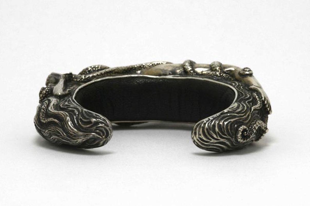 Soft black leather lines the inside of this custom made sterling silver heavy cuff.