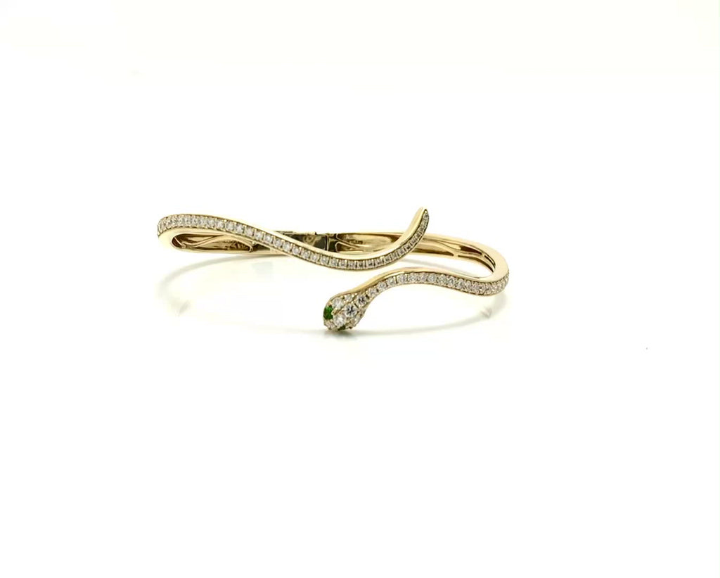 Over 1 carat of round diamonds line the outside of this modern snake bracelet.