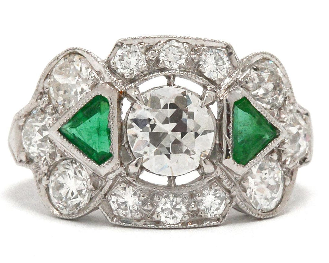 Old European brilliant diamond engagement ring with emeralds.