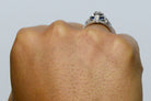 There is a parallel blue sapphire stripe in the middle of this white gold ring. 
