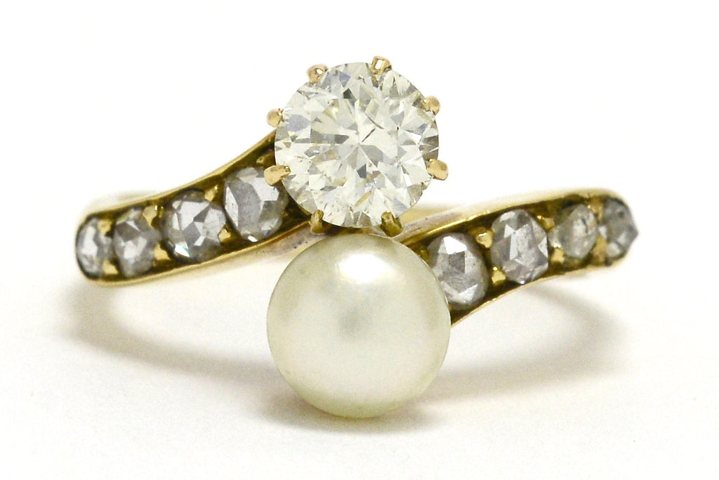 A 2 stone pearl and diamonds solitaire engagement ring.