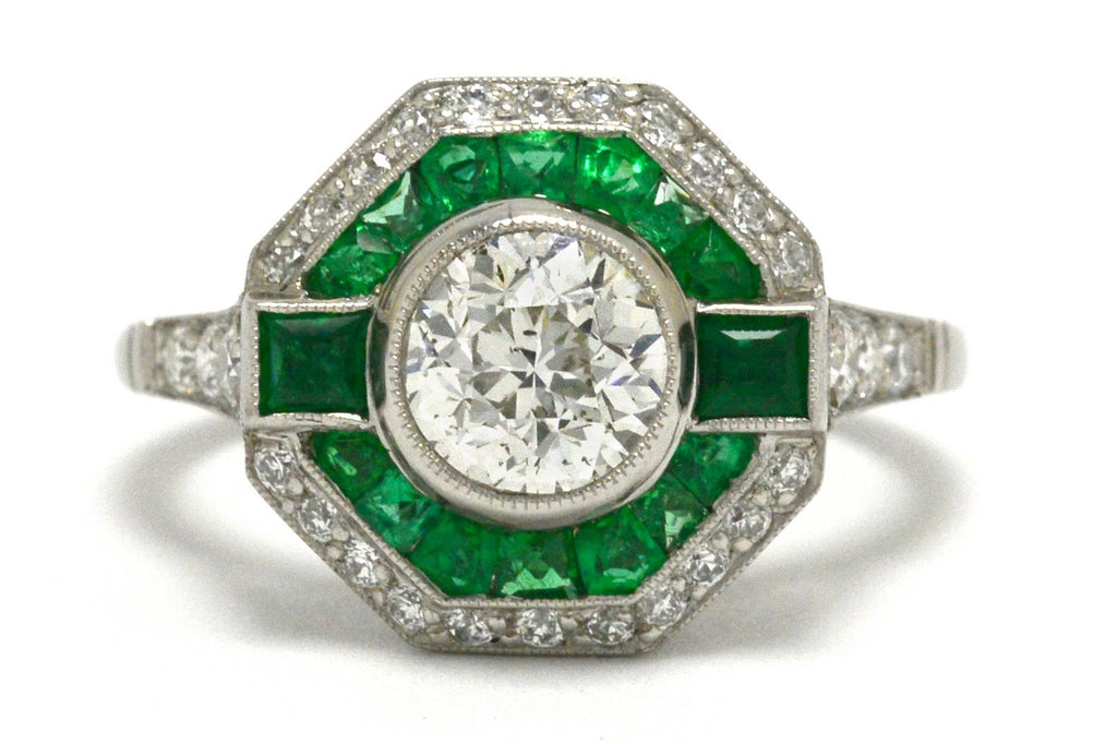 A unique octagon Art Deco diamond engagement ring with an emerald halo.