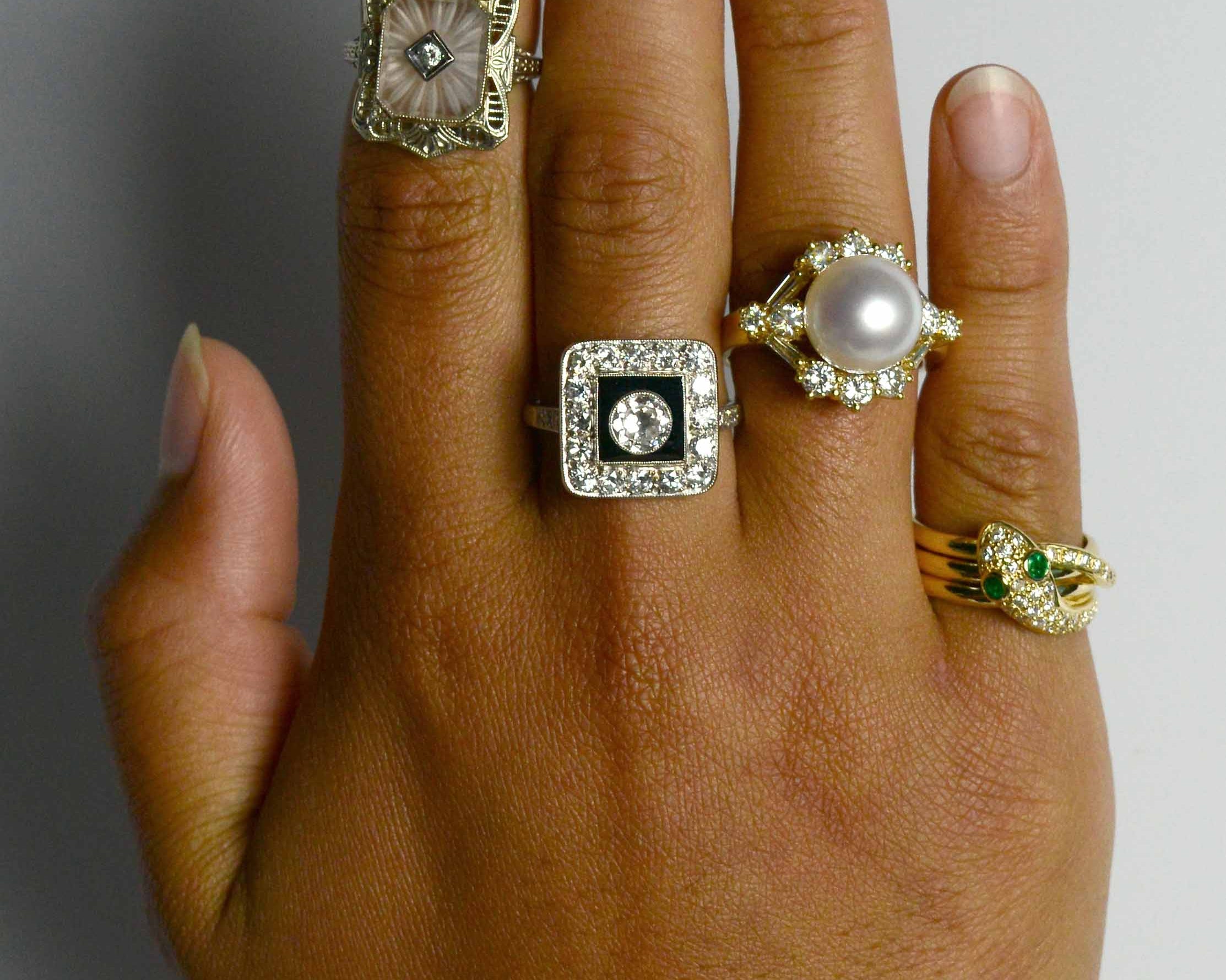 A collection of unique gem and diamond halo statement rings.