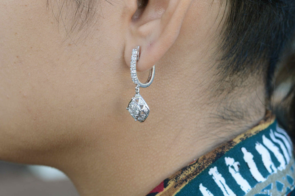 18k white gold diamond earrings sparkling in the sunlight.