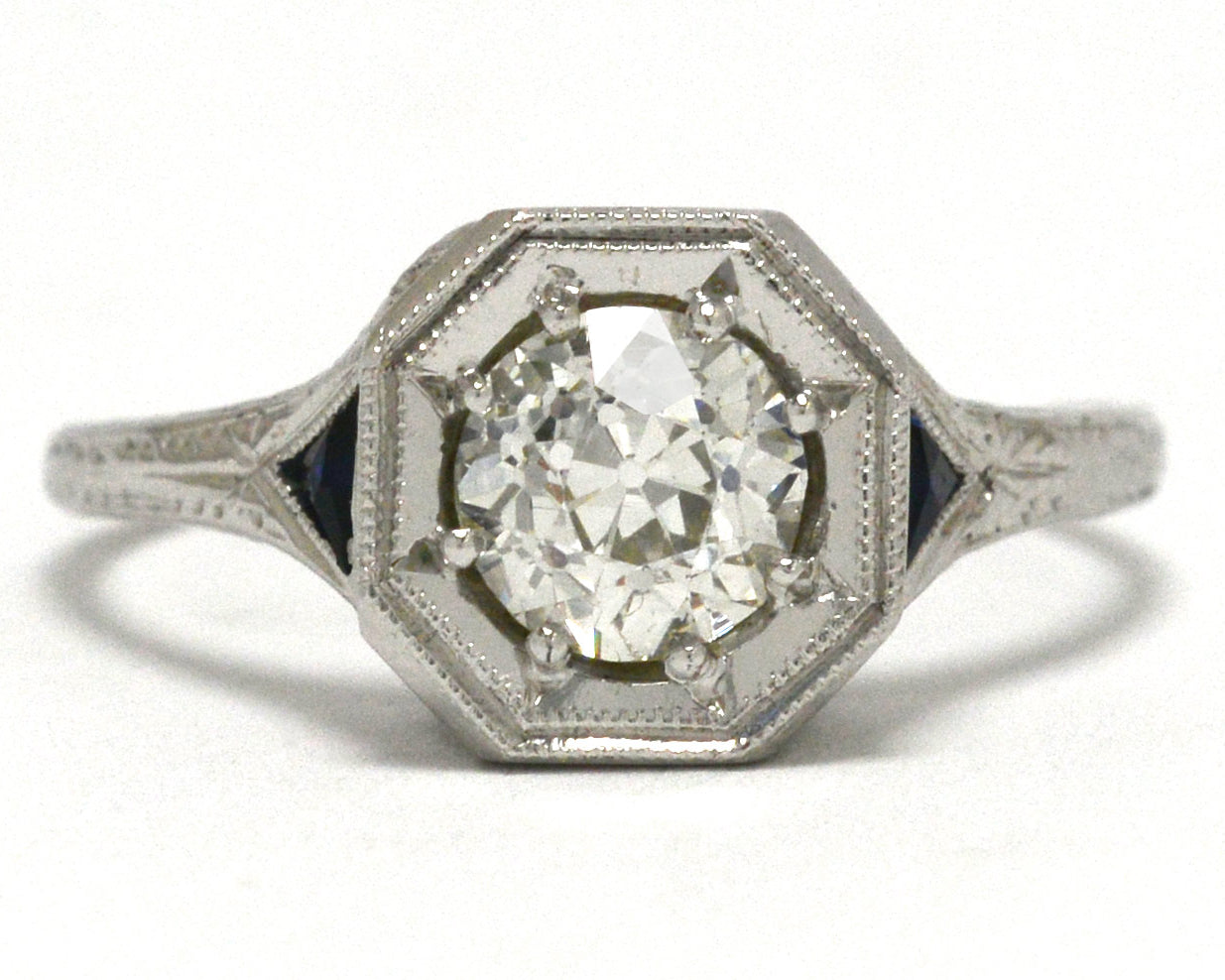 An antique old european diamond three stone engagement ring with sapphires.