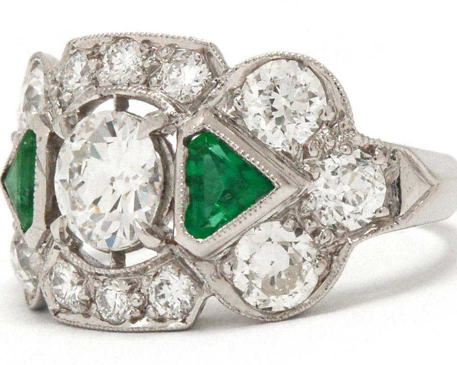 Triangle step cut emeralds diamond engagement ring.