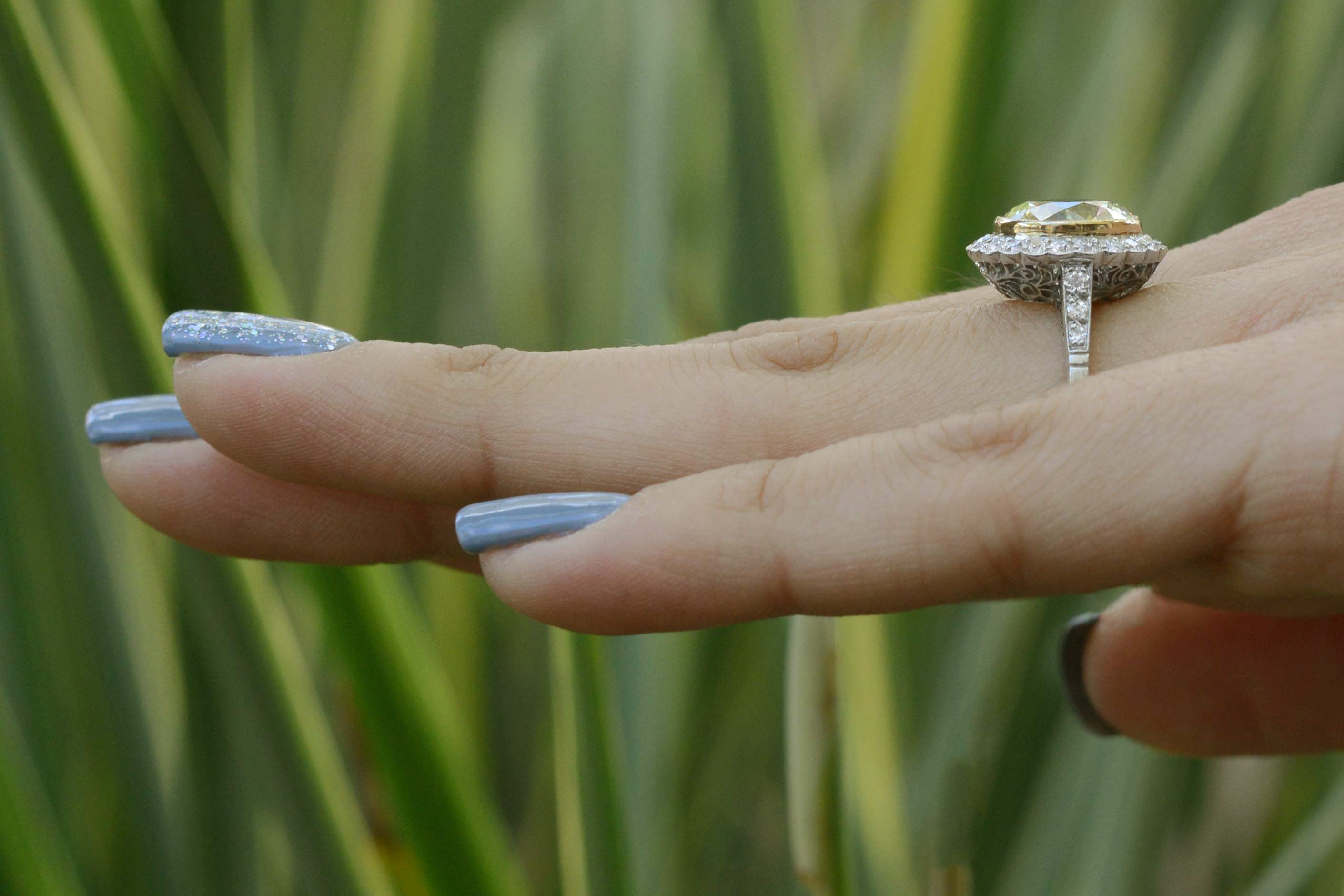 A yellow with vvs clarity diamond halo engagement ring.