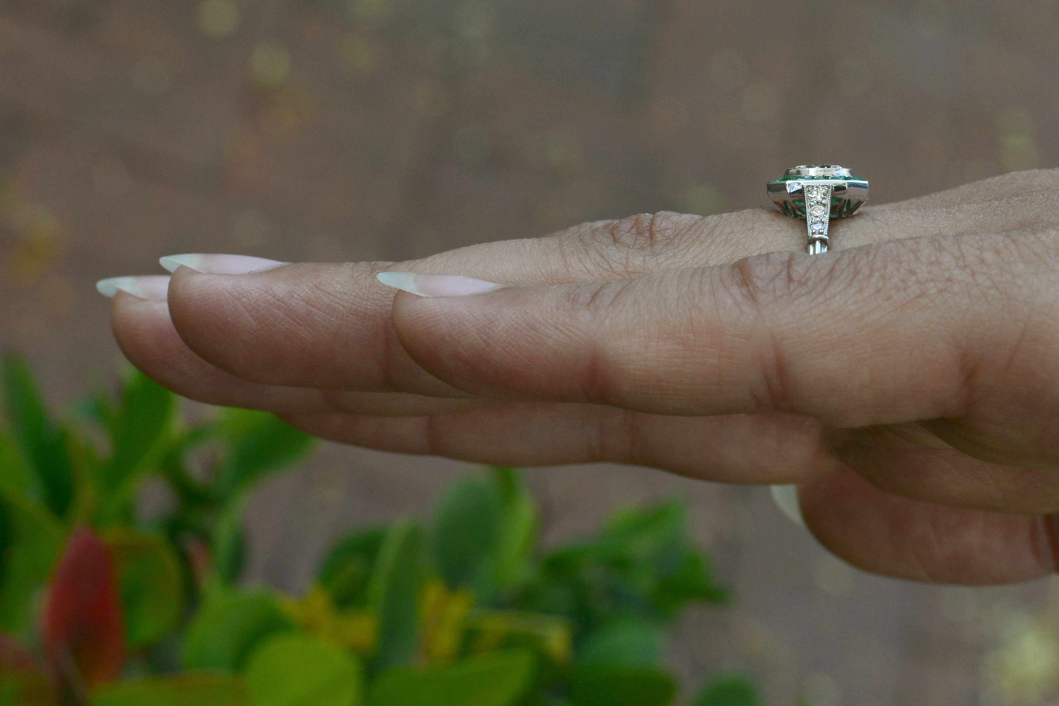 A diamond emerald wedding ring with diamonds on the shank.