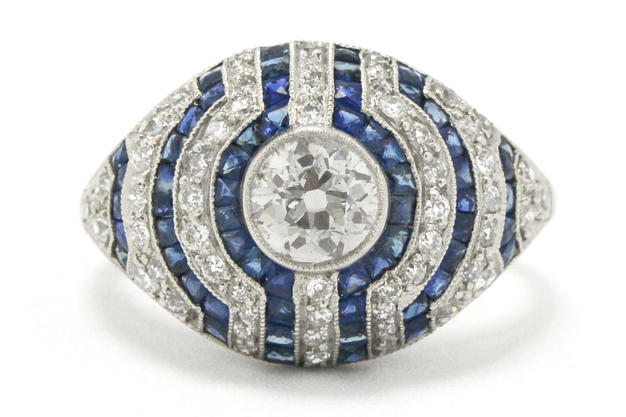 A stripe pattern diamond and blue sapphires engagement ring.