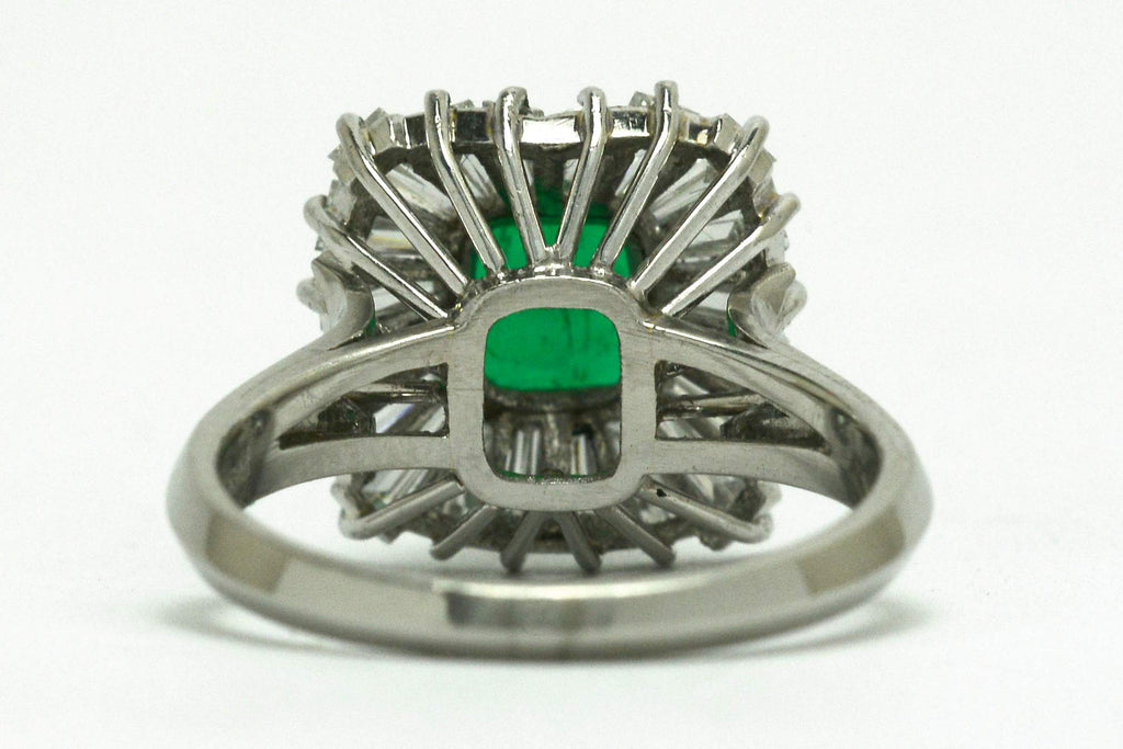 A mid century platinum emerald diamond geometric ballerina ring.