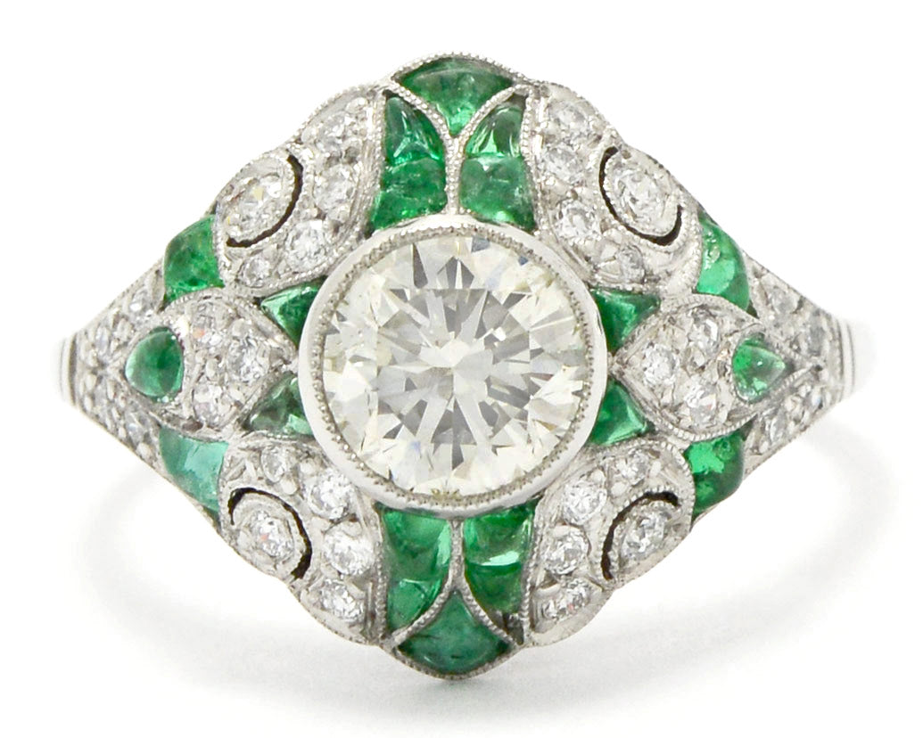 A French Art Deco diamonds and emeralds platinum ring.