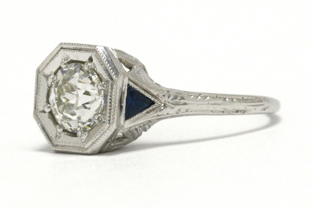 An antique old European cut diamond engagement ring with triangle sapphires.