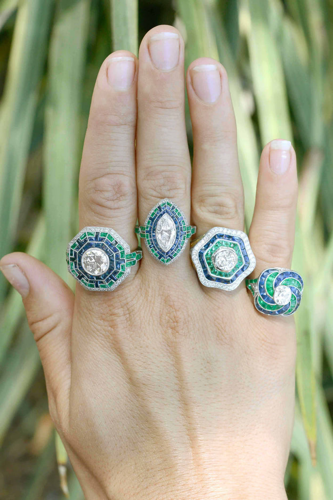A collection of diamond, emerald and sapphire statement rings.
