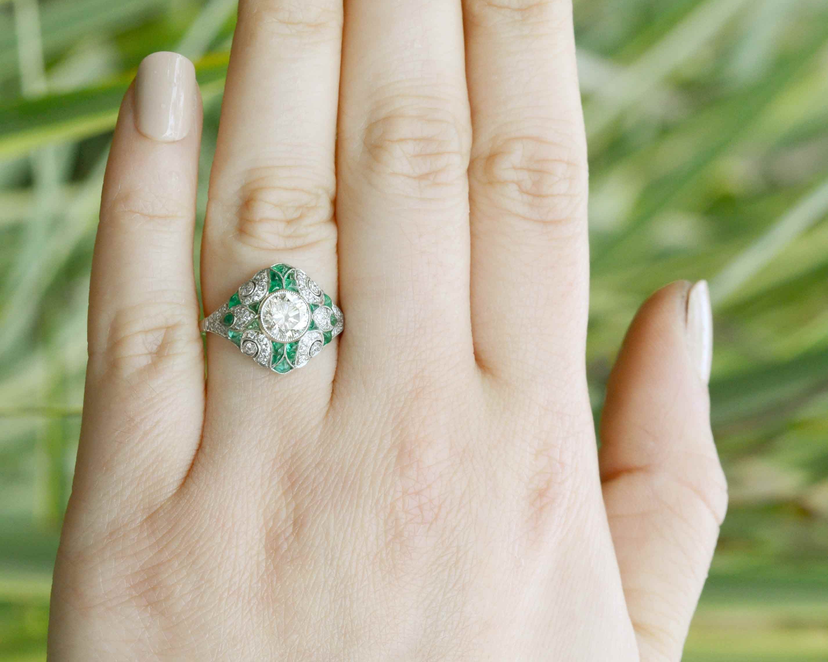 An N color with Vs2 clarity diamond is set in this stunning emerald ring.