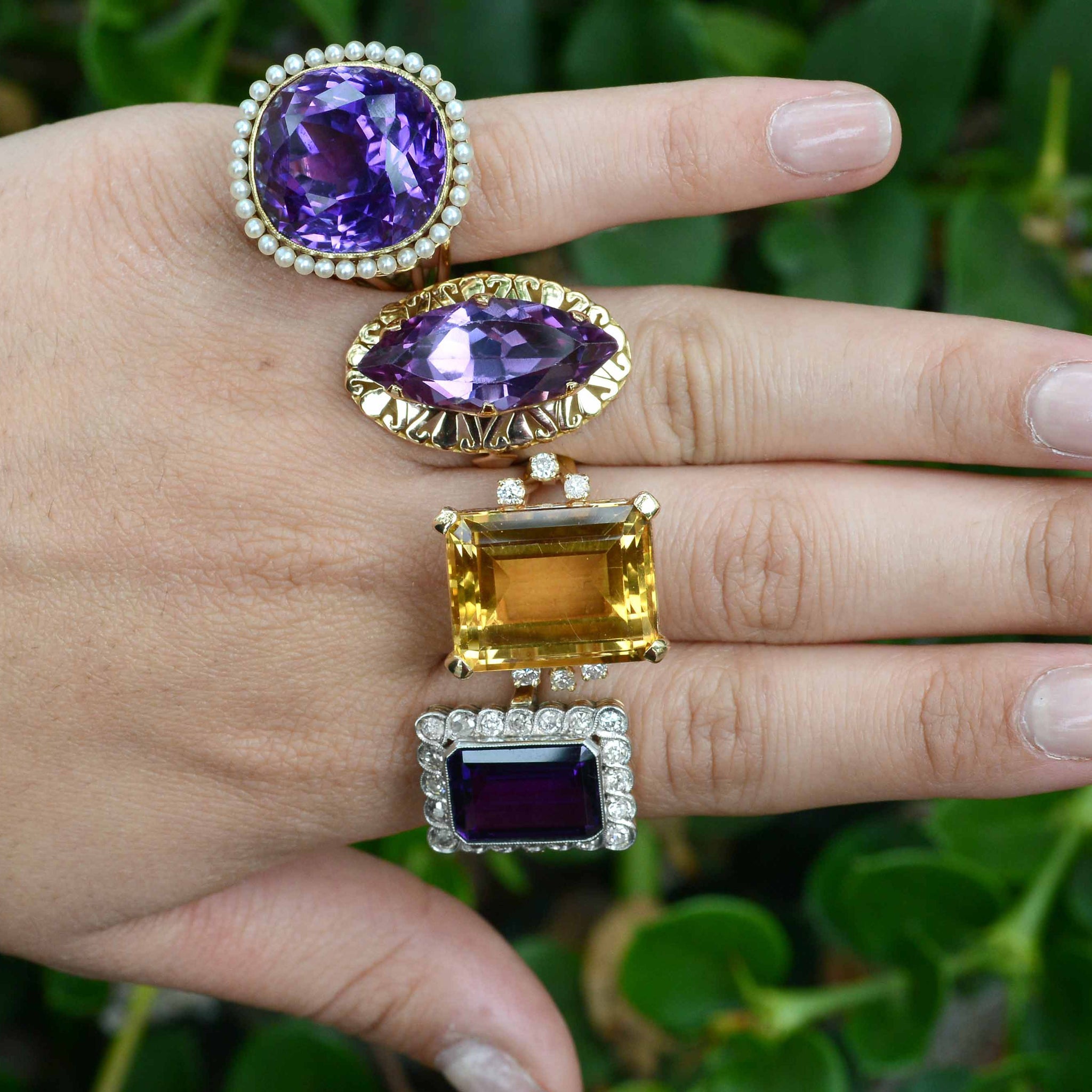 A collection of unique amethyst gold statement rings.