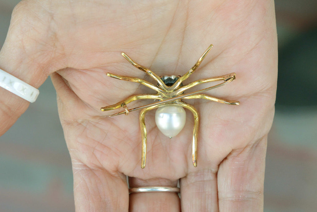 This gold spider brooch pin is a unique example of arachnid jewelry.