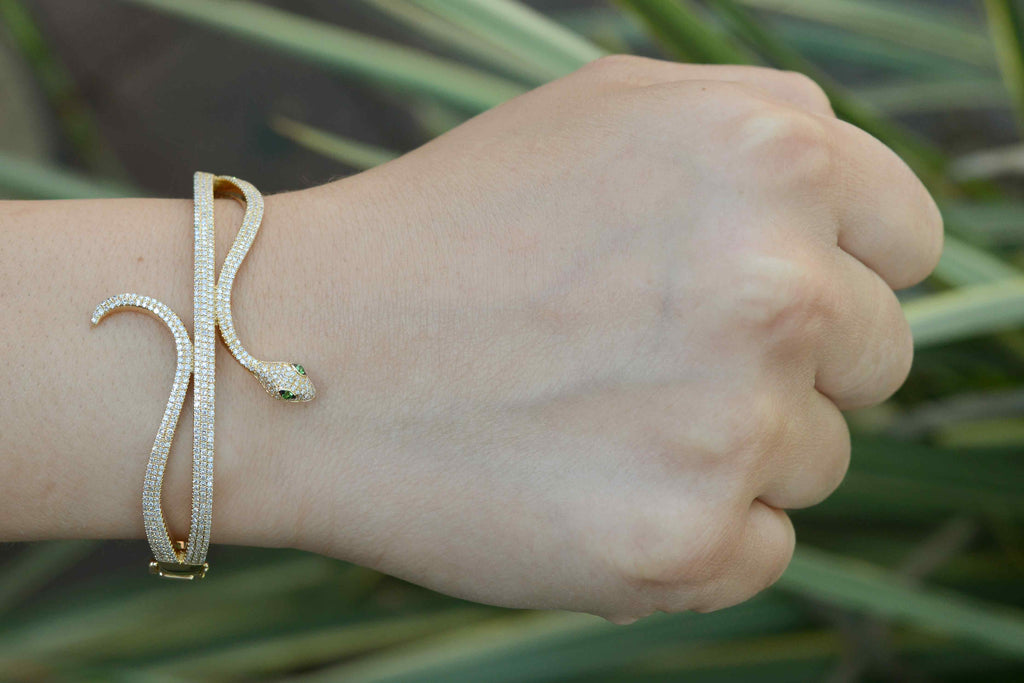 A gold Egyptian revival bracelet styled as a serpent bangle.