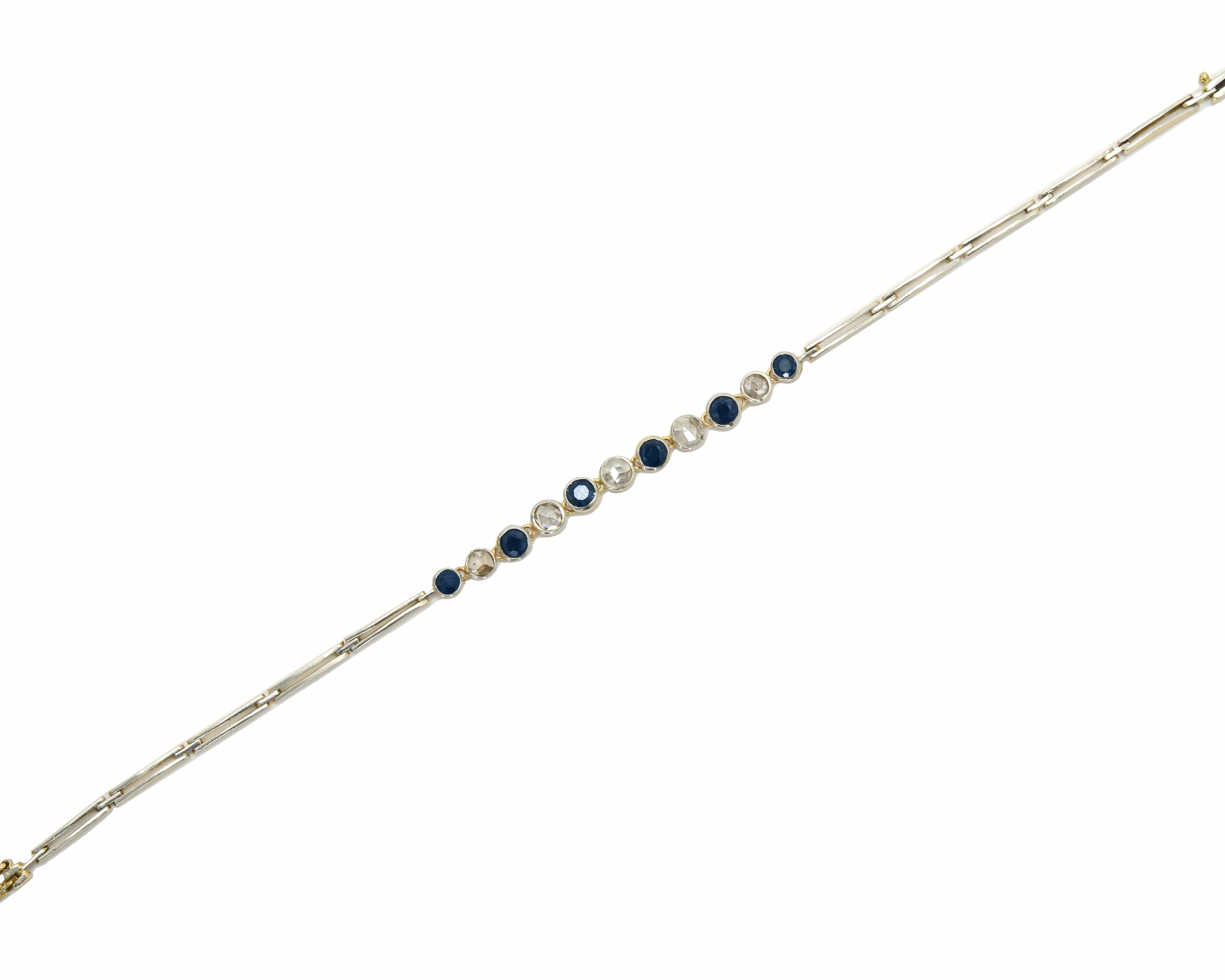 A 2 tone antique link bracelet with blue sapphires and diamonds.
