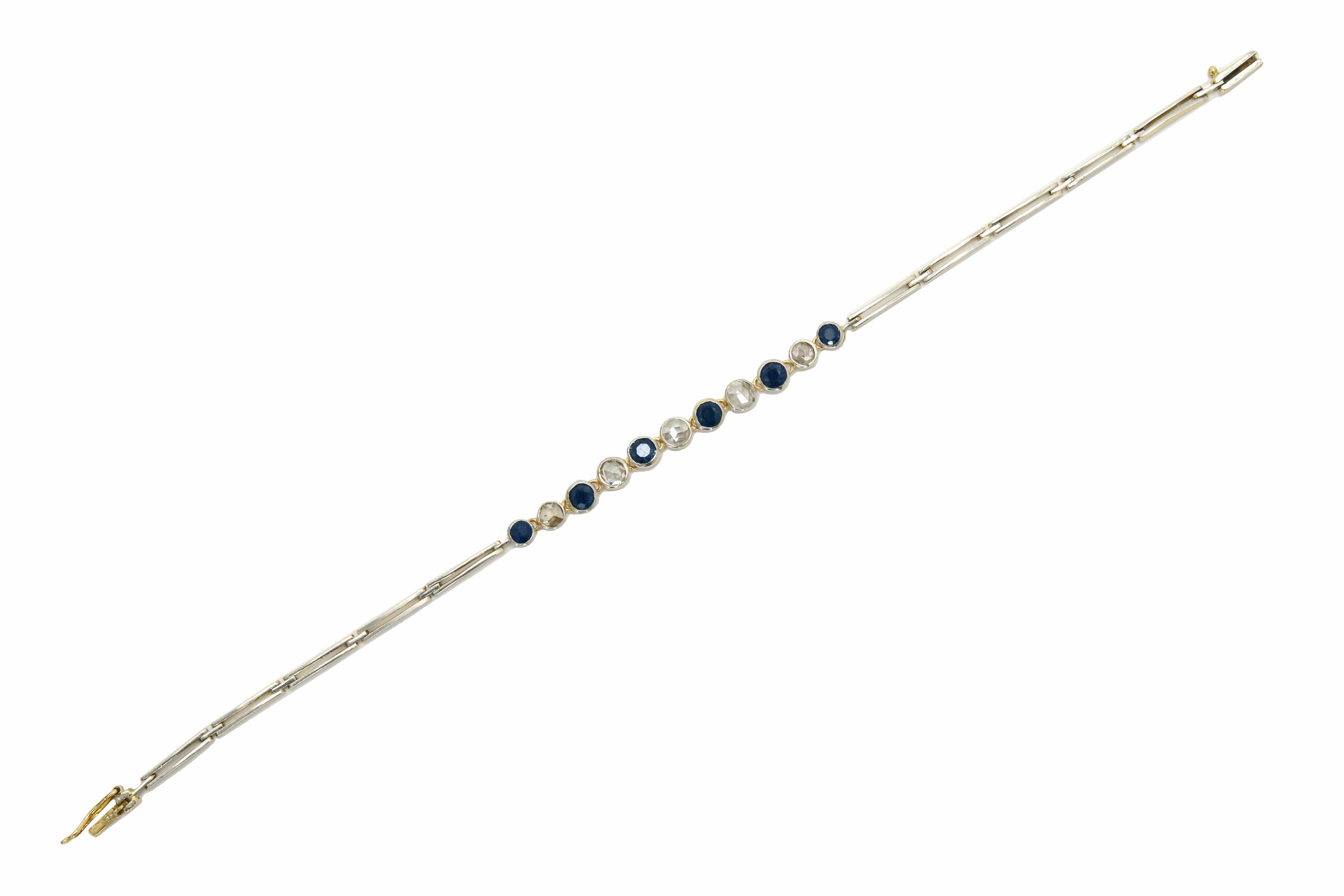 A 2 tone antique link bracelet with blue sapphires and diamonds.