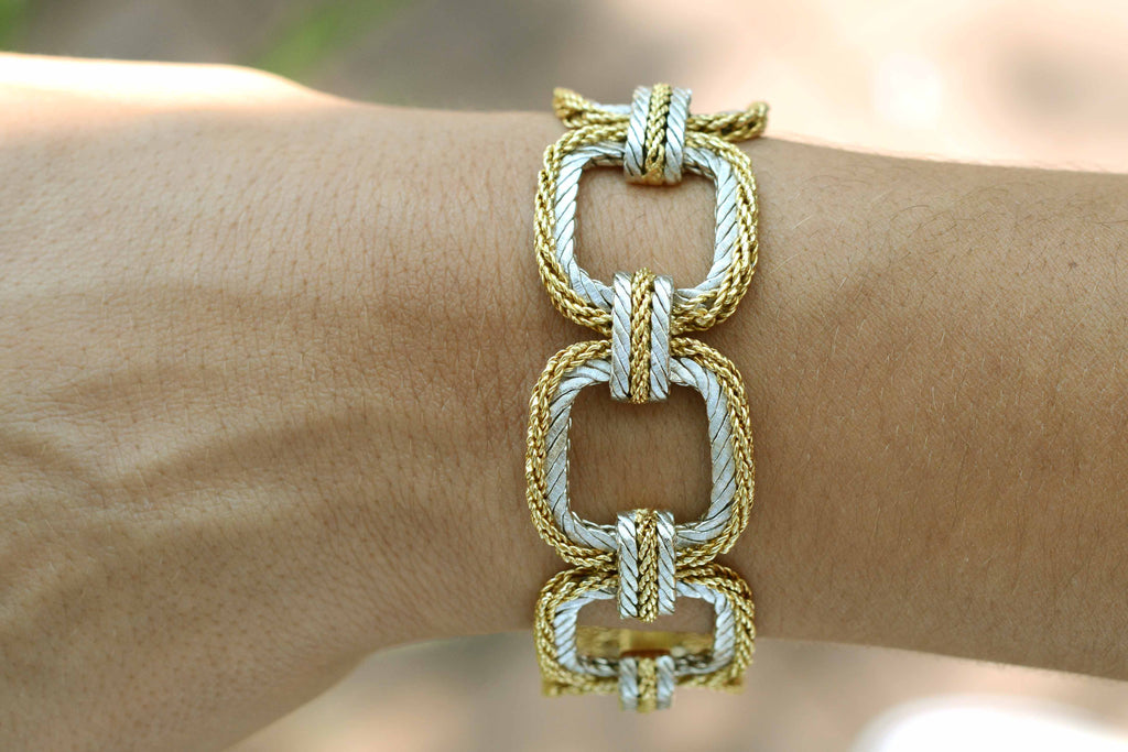A designer square link bracelet made from white and yellow gold.