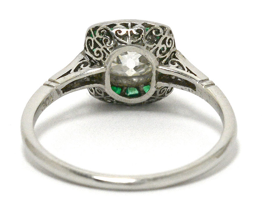 The bottom of this antique Art Deco solitaire with emeralds.