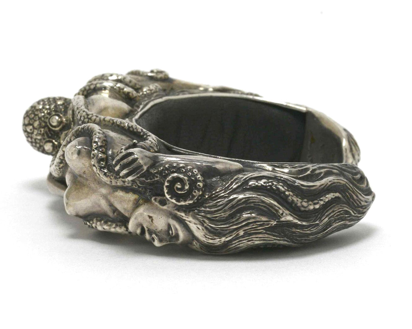 These are hand crafted silver and black leather cuffs by french artisan Lou. 