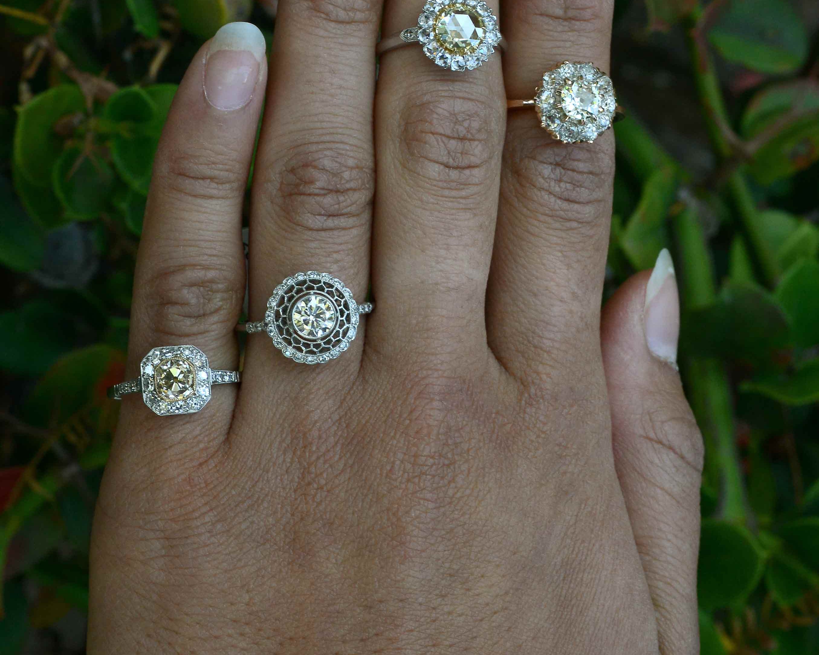 Antique revival diamond halo cluster rings.