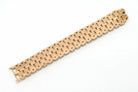The underside of an industrial design gold bracelet.