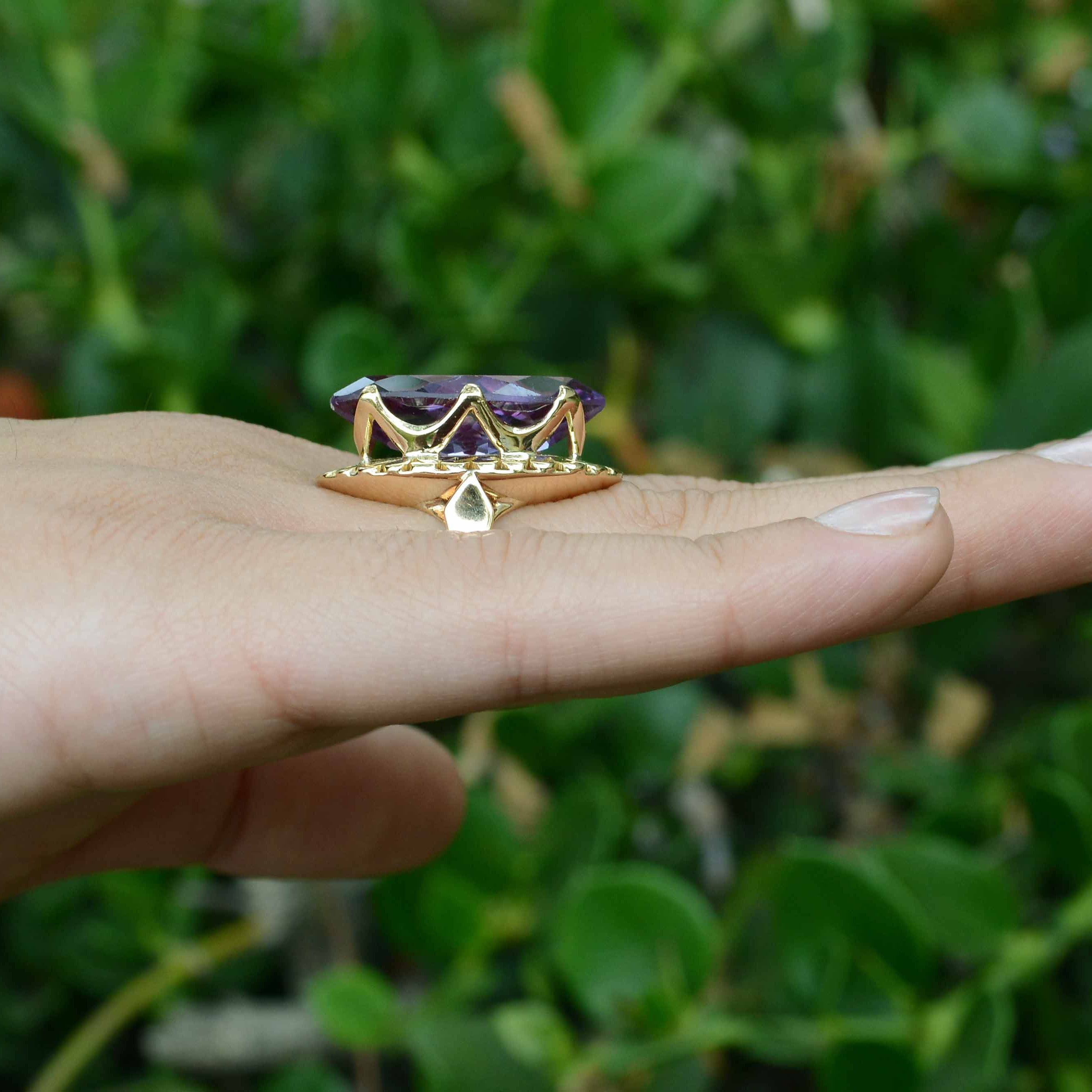 A long, navette shaped, 14k gold amethyst cocktail ring.