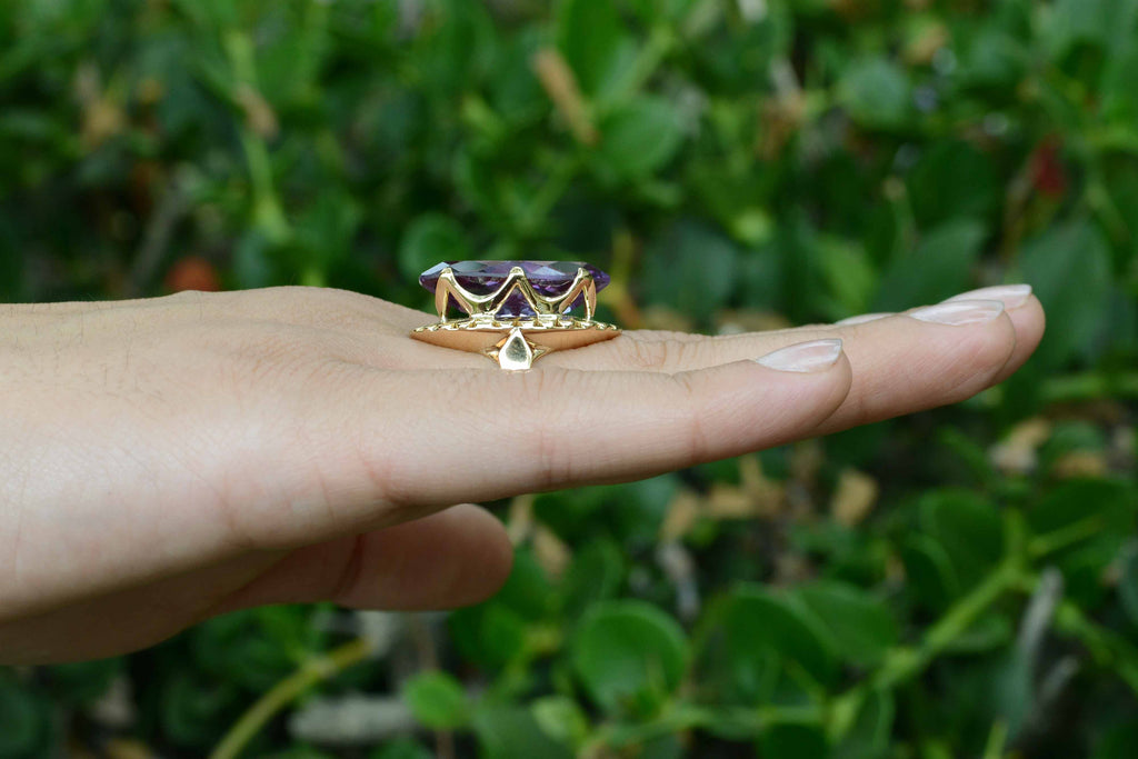 A long, navette shaped, 14k gold amethyst cocktail ring.