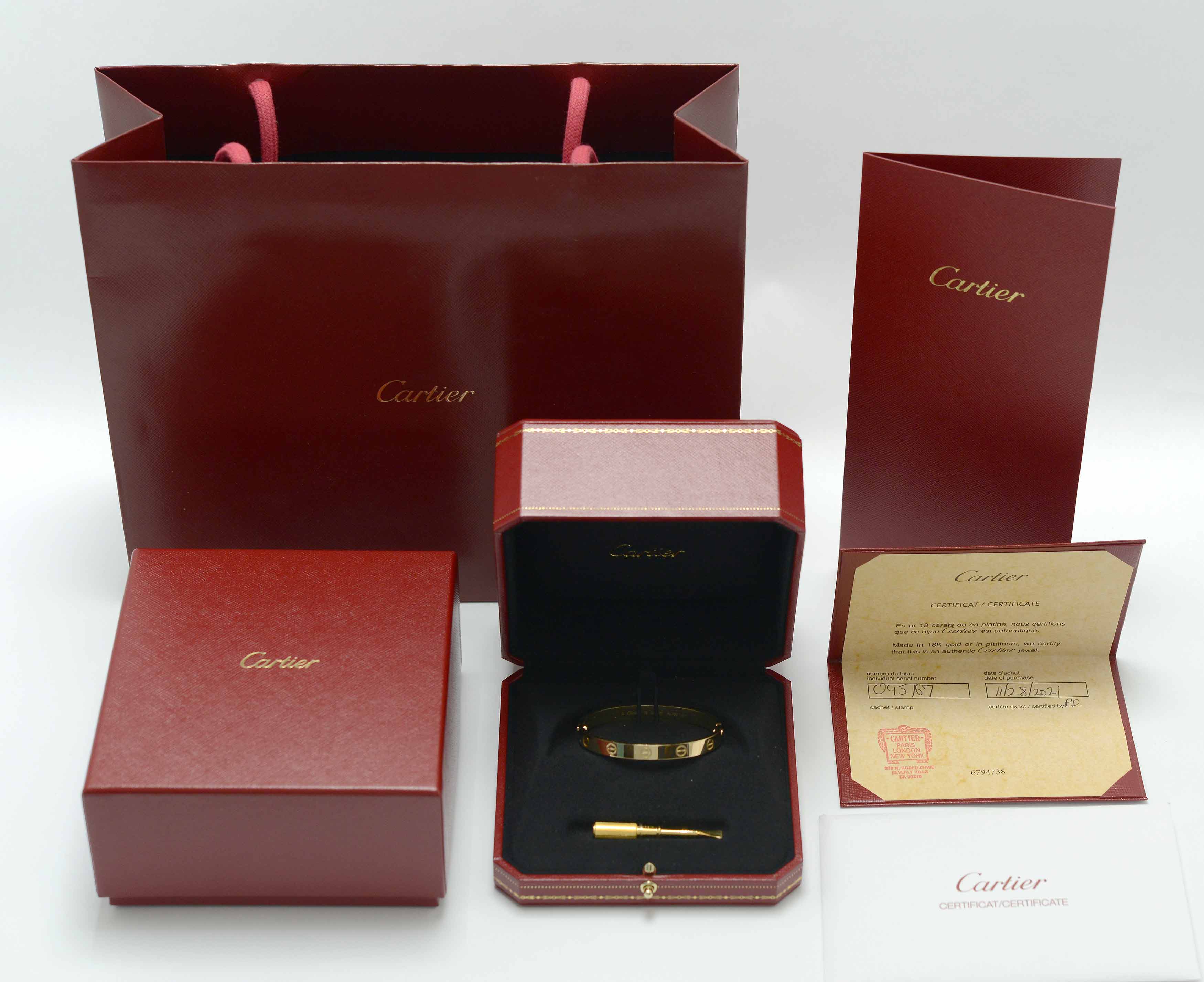 A new, authentic 18k gold Cartier love bracelet with certification.
