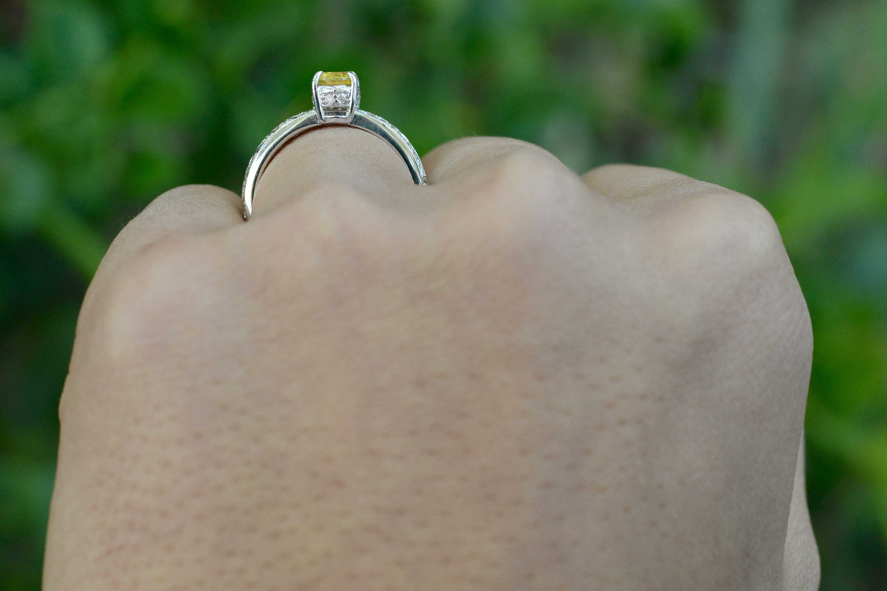 Yellow sapphire 18k white gold engagement ring with a crown setting.
