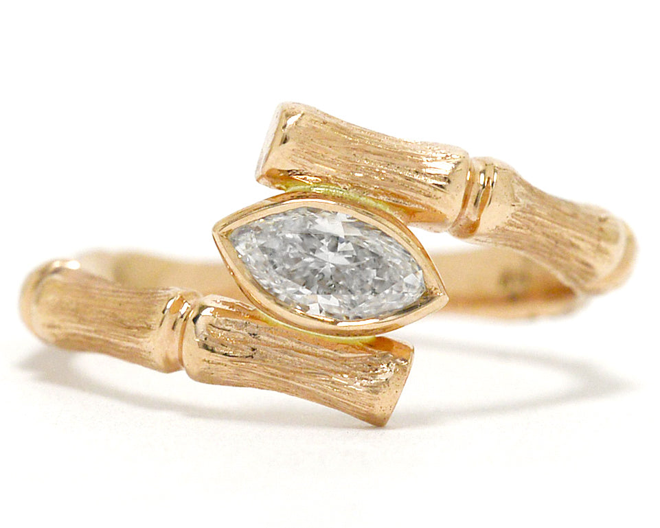A bamboo marquise diamond solitaire engagement ring.