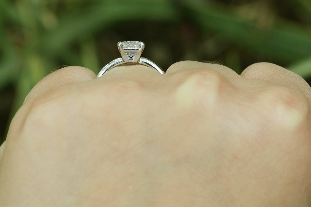 A square setting, single princess diamond engagement ring.
