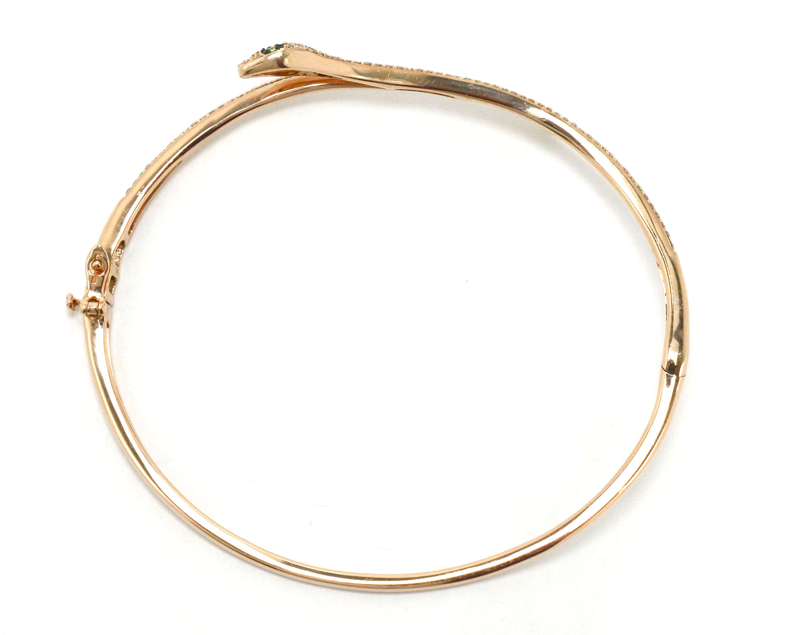 A hinged cuff gold snake bracelet.