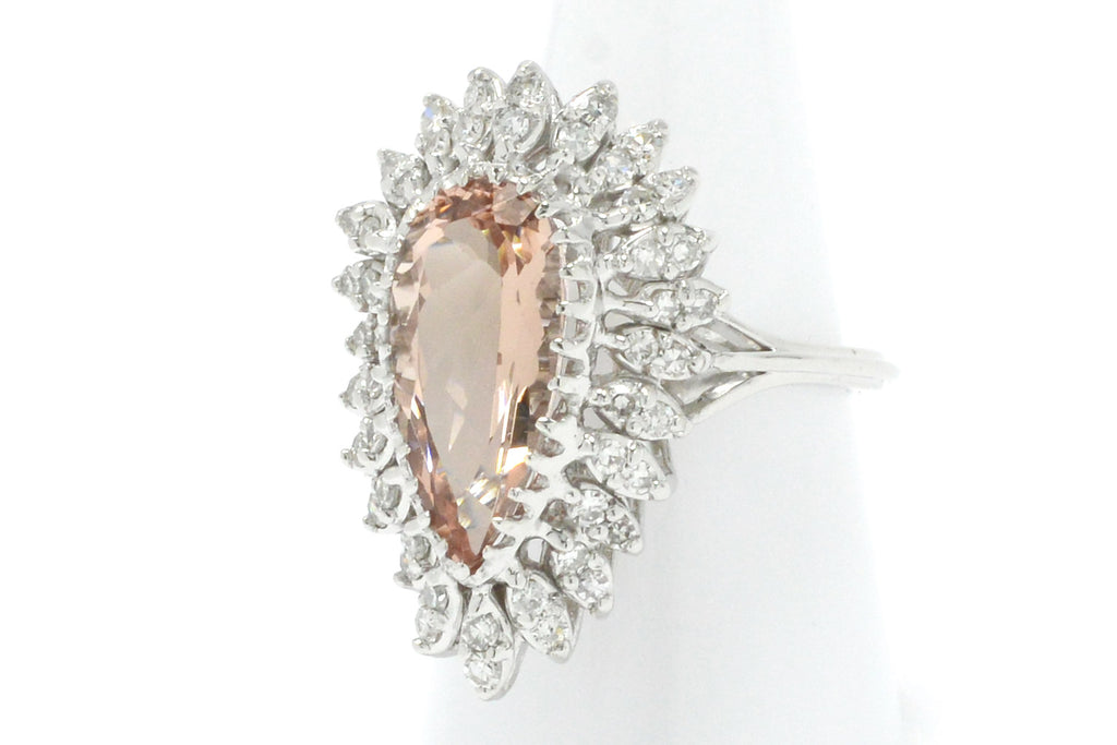 A 5 carat morganite modern estate ring with a halo of diamonds.