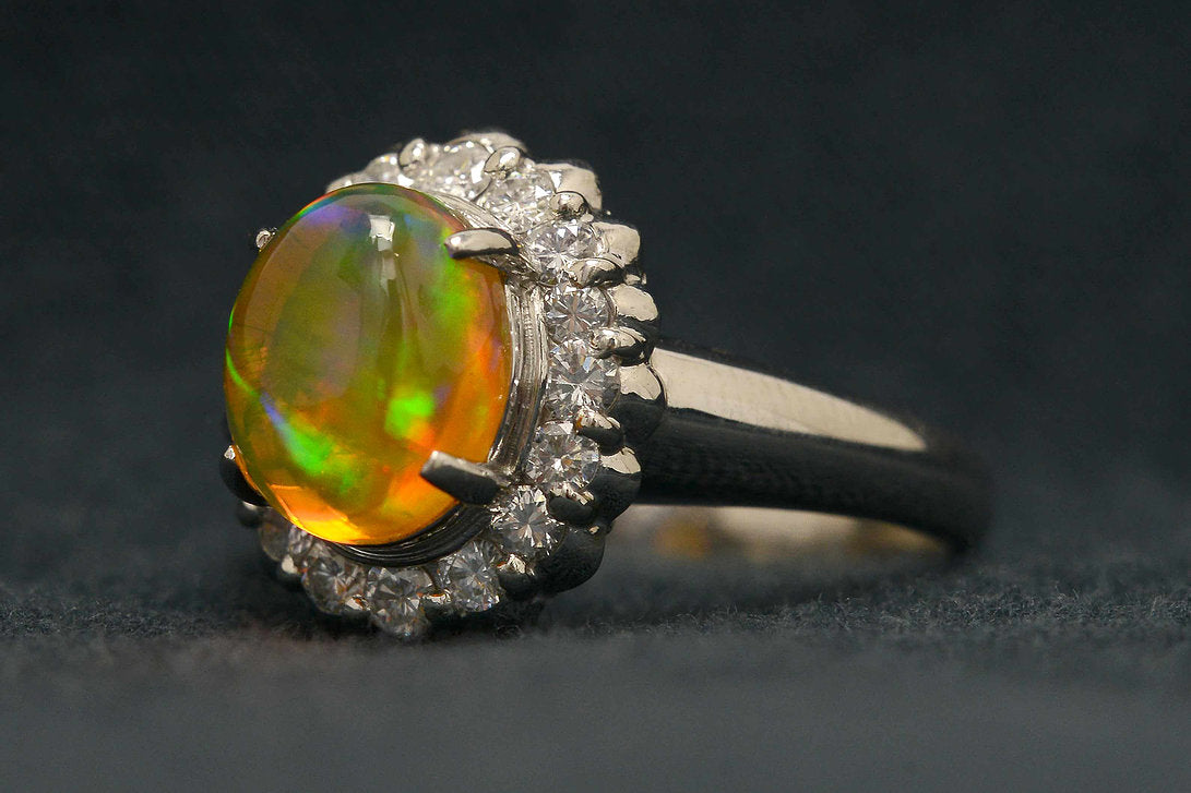 A 2 carat cabochon cut opal platinum engagement ring with a high dome.