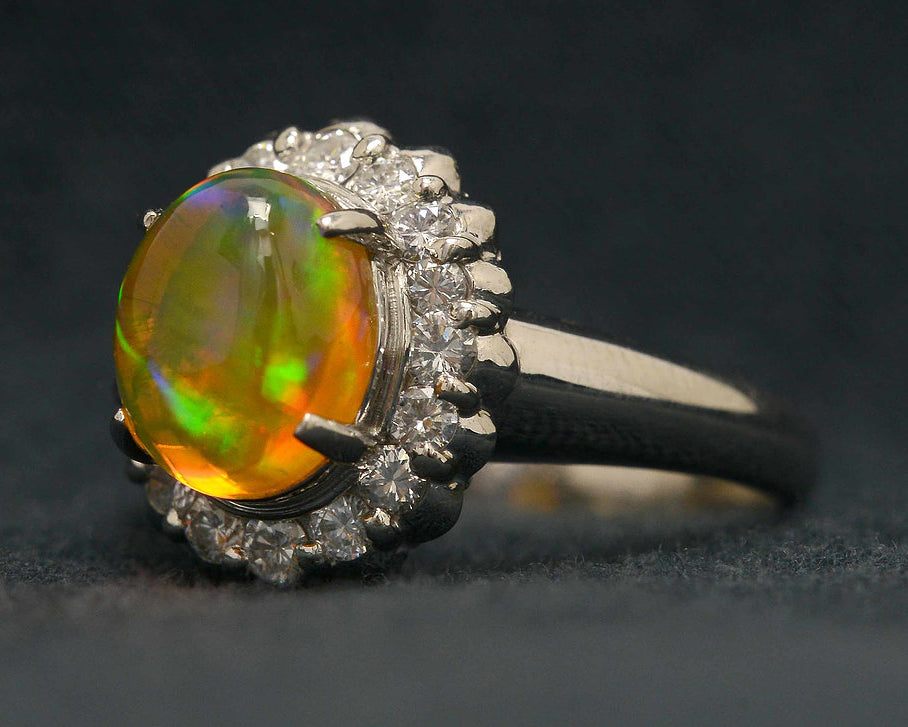 A 2 carat cabochon cut opal platinum engagement ring with a high dome.